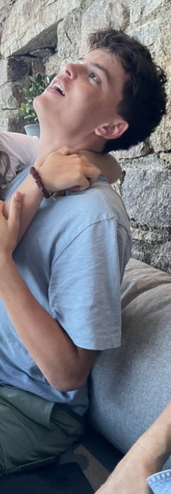 A client held at the shoulders during a fitting